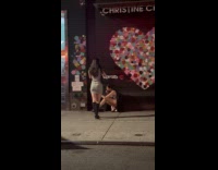 Woman crouches with makeup for sidewalk photoshoot Part 2