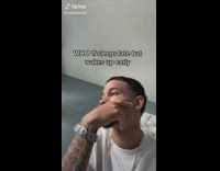 Guy white shirt hand on face thinking looking to side