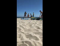 Three guys flex muscles split sunny beach