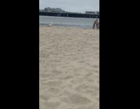 Two girls beach sand pier kids play 