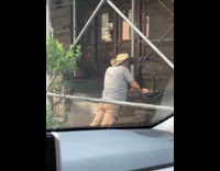 Elderly man stretching at foot of stairs