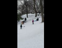 Guy rides pool float down snow hill 