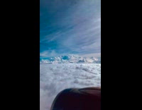 Airplane Travel Above Inverted Clouds in Sky