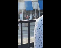 Red shirt guy stands trash can goodwill 