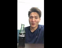 Guy flicks glass bottle breaks top half 