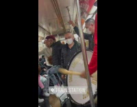 Group of men beating drums on the subway train