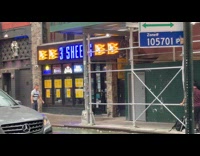 Guy does monkey bar exercise at scaffolding