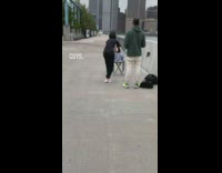 Lady photographs dog wearing sweater and beanie 