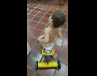 Young boy ride tricycle struggle to get out
