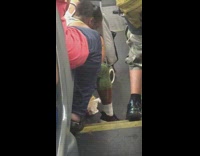 Woman steps on crab legs on bus floor to crack it open and then eats it