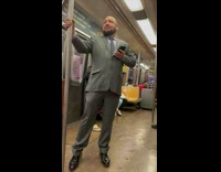 Collab Subway Creatures - Man in gray suit listen to music and sing quietly