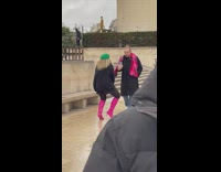Woman in pink boots tiktok dance at the park
