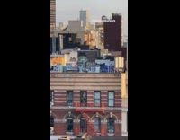 Guy practicing archery on the rooftop of his building 
