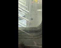 Crowded train car next to empty train car