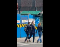 Man crossing with pigeon resting on backpack