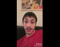 Guy red shirt  trying to follow tiktok smiling tutorial