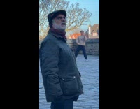 Man brown sweater tiktok dance at park