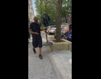 Guy walks with electric fan 