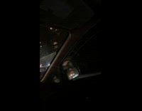 Black van in car accident with van driven up on road divide 
