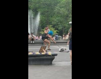 Guy in blue wig jump over spinning objects 