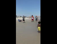 Philadelphia Flyers mascot run with man beach