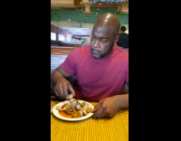 Guy records himself eating in a restaurant