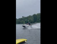 Guy on jet ski drifts on lake 