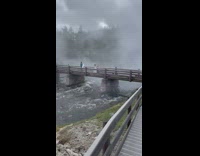 Girl white dress wooden bridge geyser steam
