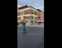 Person on tall stilts under outfit walks across the road
