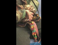 Green camouflage jacket girl holds ferret train 