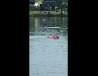 Girl pink inflatable tube white drone lake 