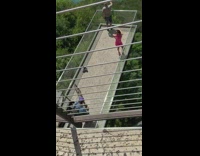 Pink dress girl balcony viewpoint blue ocean 