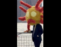 Man standing wears spider headdress hold cigarette