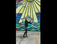 Woman does tricks with 2 hoola hoops 