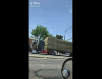 Guy says hay to truck with hay 
