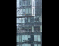 Woman throws clothes from the building window