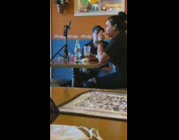 Woman black shirt tripod on diner table