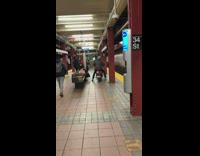 Person rides scooter on subway platform