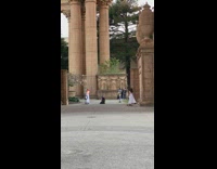 Woman Dressed in Roman Clothing Spins Ring with Fire 