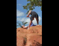 Girl tank top lay over brown rock