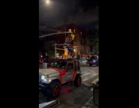 Man singing with small stage on top of jeep