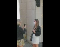White face mask girl walks towards friend 