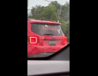 Red jeep car in traffic with fkdmkds