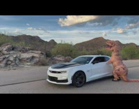 Person in dinosaur costume drive camaro car