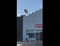 Girl jump photo outside supreme red hat 