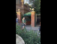 Woman in green stripes top models her bag