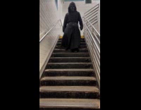 Darth Vader walks down the subway staircase