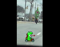 person in yoshi costume on motorcycle