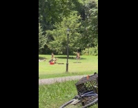 Girl dances swings around metal pole park 