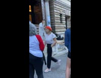 Guy chops wood in a robe 